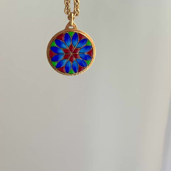 18k gold and plique a jour vibrant pendant in red colbalt blue and vibrant green with a floral motif.