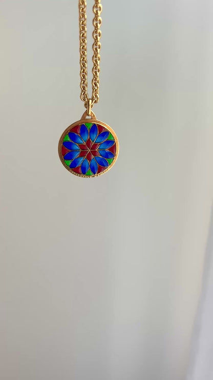 18k gold and plique a jour vibrant pendant in red colbalt blue and vibrant green with a floral motif.