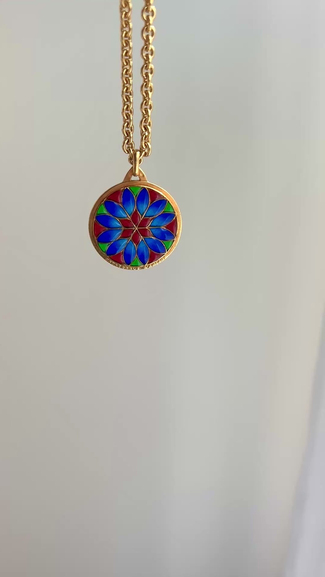 18k gold and plique a jour vibrant pendant in red colbalt blue and vibrant green with a floral motif.